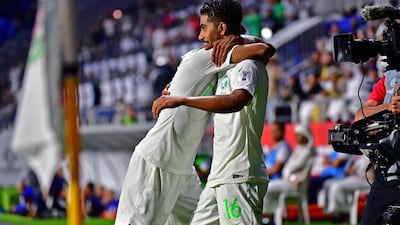 Saudi Arabia's Hussain Al Moqahwi, right, celebrates after scoring against Lebanon at Al Maktoum Stadium in Dubai. AFP