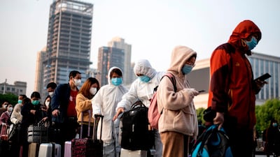 People wearing face masks arrive at Hankou Railway Station in Wuhan to take one of the first trains leaving the city. AFP