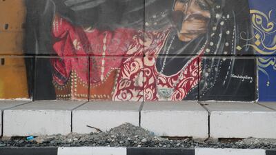 A woman in an abaya by Malak Gallery.