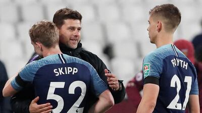 Tottenham manager Mauricio Pochettino celebrates his side's League Cup win over West Ham United with players Oliver Skipp and Juan Foyth. Reuters
