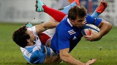 France's Vincent Clerc is brought down by Argentina's Nicolas Sanchez