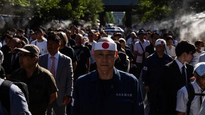 Visitors line up to offer prayers at the Yasukuni Shrine in Tokyo on the 80th anniversary of Japan's surrender in the Second World War. AP