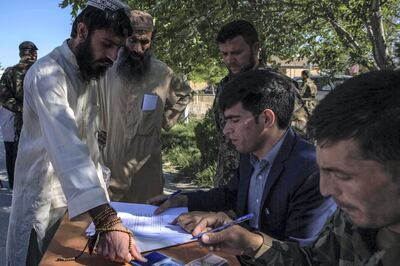 Abdullah Wasi, 27, (here, fingerprinting a form) said after his release, he would do “whatever God asks of me.” Prisoners sign or fingerprint a declaration saying that they won't return to the battlefield once freed. Each one receives 5,000 Afghani ($65) for food and their journey home. Stefanie Glinski for The National
