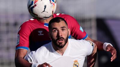 Real Madrid's Karim Benzema fights for the ball with Elche's Johan Mojica. AP