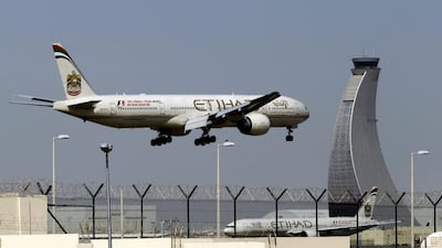 An Etihad Airways plane prepares to land at Abu Dhabi airport. Kamran Jebreili / AP Photo