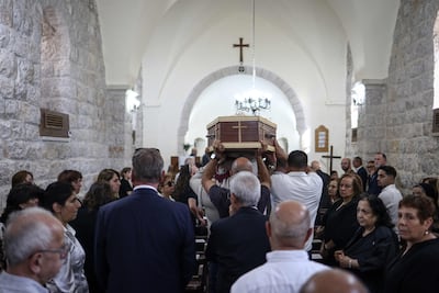 The coffin of Sliman Mansour was draped in olive branches, a key motif of the Palestinian artist's body of work. AFP