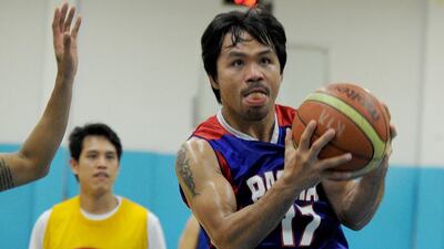 Manny Pacquiao shown with his Philippines Basketball Association team, Kia Motors. Jay Directo / AFP