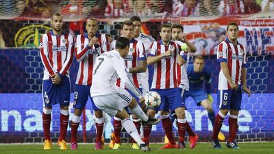 Cristiano Ronaldo of Real Madrid attempts a free kick over the Atletico Madrid wall during their Champions League quarter-final first leg match on Tuesday. Paul Hanna / Reuters