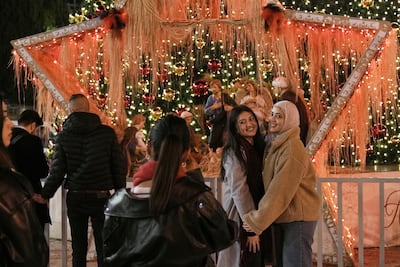 People pose for a picture in Manger Square in the occupied West Bank city of Bethlehem. AP