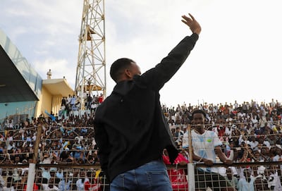 Somali referee Omar Artan waves to supportive fans at the Mogadishu stadium after being refused entry to the US. Reuters