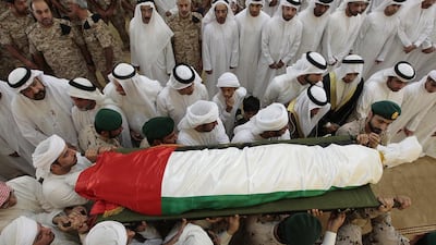 Family and friends carry the body of Nasser Al Blooshi after dhuhr prayers at the Armed Forces mosque in Merashed. Jeffrey E Biteng / The National