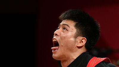 China's Li Fabin on his way to victory in the Men's 61kg Weightlifting.