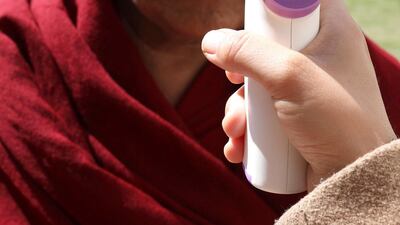 A doctor checks the temperature of a Tibetan man, living-in-exile in India, outside the Tibetan Parliament house during the Parliament session at Dharamsala, India. EPA