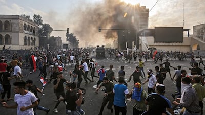Protesters clash with an Iraqi riot police vehicle during a demonstration against state corruption and poor services, between the capital Baghdad's Tahrir Square and the high-security Green Zone district. AFP