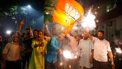 Supporters of India's ruling Bharatiya Janata Party (BJP) light firecrackers and celebrate the government revoking Kashmir's special status, in Lucknow, India. AP