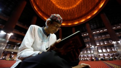 Indonesian Muslim man reads the Quran as he waits for iftar during Ramadan at Istiqlal mosque in Jakarta, Indonesia. Reuters