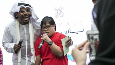 A boy recites a poem on stage. Mona Al Marzooqi / The National