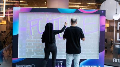 Participants spray paint a digital canvas