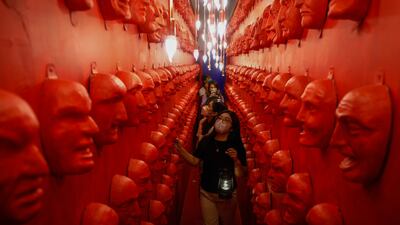 Visitors come face to face with spooky masks at Whimsical Wonderland in Quezon City, Philippines. EPA