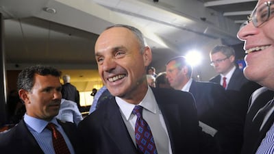 Major League Baseball Chief Operating Officer Rob Manfred, centre, is all smiles after team owners elected him as the next commissioner of Major League Baseball during an owners quarterly meeting in Baltimore,on Aug. 14, 2014. Steve Ruark / AP Photo