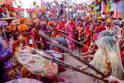 Women playfully hit revellers with sticks as a traditional ritual during the Lathmar Holi celebrations in India's northern state of Uttar Pradesh. AFP