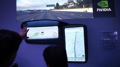 A show attendee checks out the Nvidia DRIVE CX autonomous driving system. Alex Wong / Getty Images / AFP