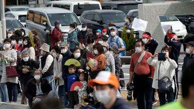 Locals wait for torchbearers at the first section of the Torch Relay in Naraha. AP