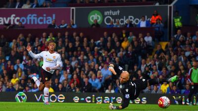 Memphis Depay of Manchester United shoots wide of the goal as Brad Guzan of Aston Villa dives at the ball during United’s Premier League win on Friday night. Michael Regan / Getty Images / August 14, 2015