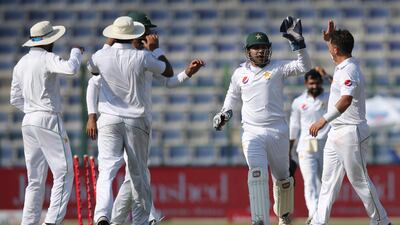 Pakistan celebrate the dismissal of Sri Lanka's Dimuth Karunaratne in Abu Dhabi on Thursday. Kamran Jebreili / AP Photo