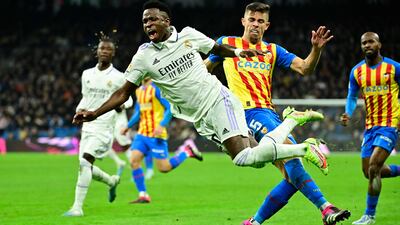 Valencia's Brazilian defender Gabriel Paulista (R) fouls Real Madrid's Brazilian forward Vinicius Junior during the Spanish league football match between Real Madrid CF and Valencia CF at the Santiago Bernabeu stadium in Madrid on February 2, 2023. (Photo by JAVIER SORIANO / AFP)