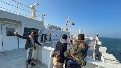 People tour the deck of the Galaxy Leader commercial ship, seized by Yemen's Houthis last month, off the coast of al-Salif, Yemen. Reuters