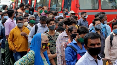 People wait to board buses during rush hour in Mumbai, the main city in India's Mahrashtra state where a lockdown was declared on April 5, 2021 as the country's daily coronavirus infections rose past 100,000. Reuters