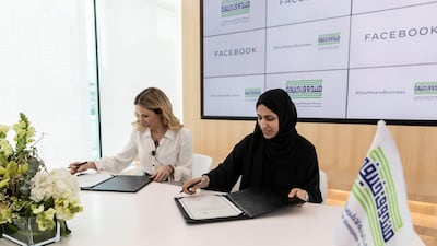 Mouza Al Nasri (R), acting chief executive of Khalifa Fund, signing partnership agreement with Derya Matras, Facebook’s regional director for Middle East, Africa and Turkey, in Abu Dhabi on Wednesday. Antonie Robertson / The National