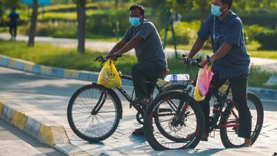 Cyclists carrying their lunch take a spin on the Corniche. Victor Besa / The National