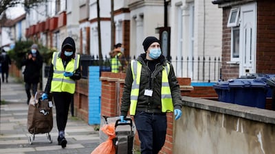 Volunteers deliver coronavirus test kits to local residents as part of surge testing for the South African variant of Covid-19 in London. AFP