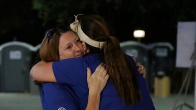 Gilroy Garlic festival volunteer Denise Buessing, left, embraces fellow volunteer Marsha Struzik after the shooting. AP