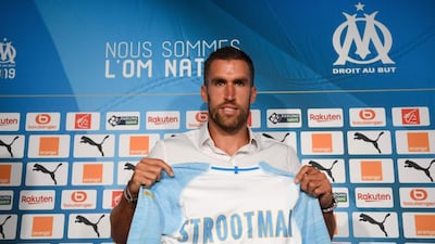 Olympique de Marseille (OM)'s Dutch midfielder Kevin Strootman poses with his new football jersey after signing from Roma. AFP