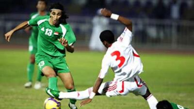 The UAE's Faris Jumaa, in white, tries to halt Iraq's Karrar Jassim late in the 2-2 draw on Saturday at Al Ain.