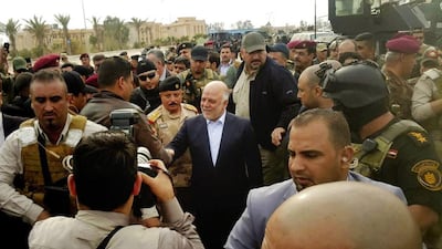 Iraqi prime minister Haider Al Abadi, centre, tours the city of Ramadi on December 29, 2015, a day after it was retaken from ISIL by security forces. AP Photo