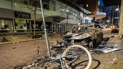 Dutch police fired warning shots, injuring at least two people, after rioters torched a police car. AFP