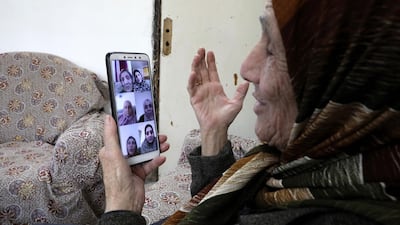 Palestinian Shahira Qafisheh, 85, video chats with her daughters during the coronavirus lockdown in the occupied West Bank city of Hebron. AFP