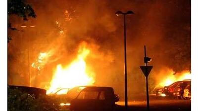 Cars burn on July 17 in the Grenoble suburb of Villeneuve, home of Karim Boudouda, a supermarket robber killed by the police the previous night.