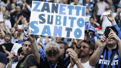 An Inter Milan fan holds up a sign. The sign reads, ”Zanetti, make him a saint now”. Zanetti’s finale was also marked by a solitary fan running onto the pitch in the 90th minute to salute the man who has come to be simply known as ‘Il Capitano’. Alessandro Garofalo / Reuters