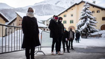 People queue during Covid-19 mass testing in Zuoz, Switzerland. AP Photo