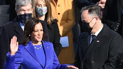 Kamala Harris, flanked by her husband Doug Emhoff, is sworn in as US Vice President by Supreme Court Justice Sonia Sotomayor on January 20. AFP