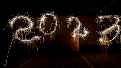 Sri Lankans writing '2023' with firecrackers during New Year's Eve celebrations in Colombo. EPA
