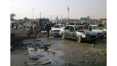 Security personnel inspect the site of a bomb attack in Ramadi, 100 km west of Baghdad. Reuters
