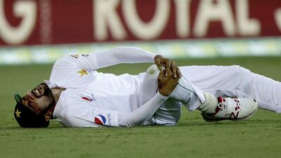 Pakistan's Mohammed Amir reacts after injuring his knee while fielding on Day 1 of the first Test against Australia on Thursday. Tertius Pickard / AP Photo / December 15, 2016