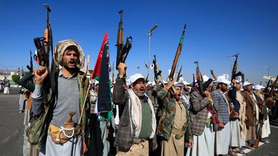 Newly recruited members of the Houthis' popular army brandish firearms at a parade in Sanaa, Yemen. EPA