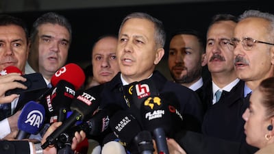 Turkish Interior Minister Ali Yerlikaya, centre, speaks to the media in the vicinity of the headquarters of the Turkish Aerospace Industries building. AFP